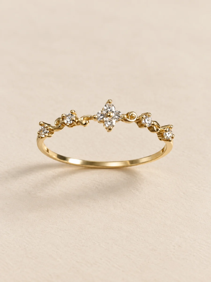 Anel dourado com flores e pedras claras em fundo bege