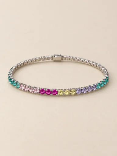 Pulseira riviera em ouro branco com pedras coloridas em fundo bege